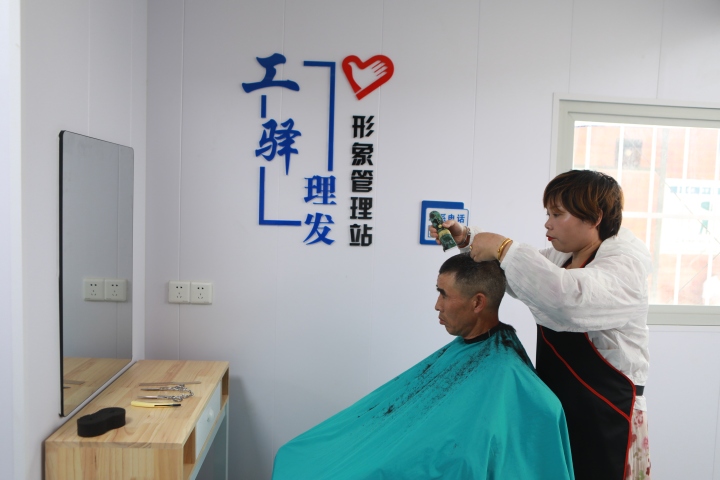 工人在工友驿站内体验免费理发服务.jpg